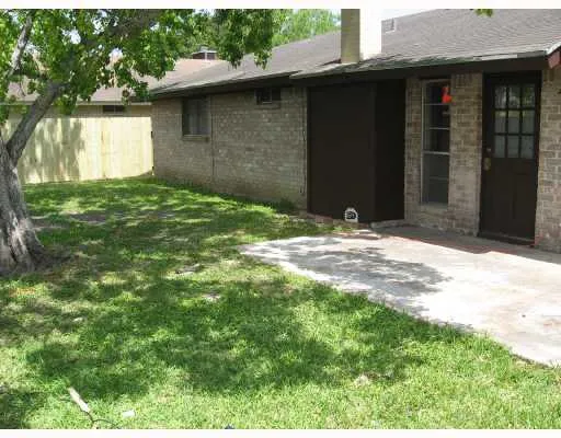 a backyard of a house with large trees