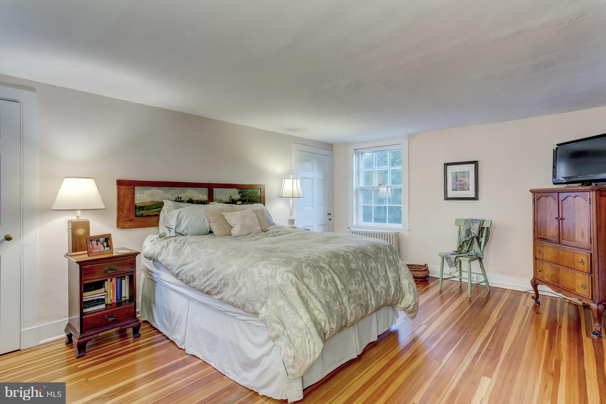 14737 Carroll Road Phoenix, MD 21131 - Photo 16 of 30 a bedroom with a bed and a flat screen tv