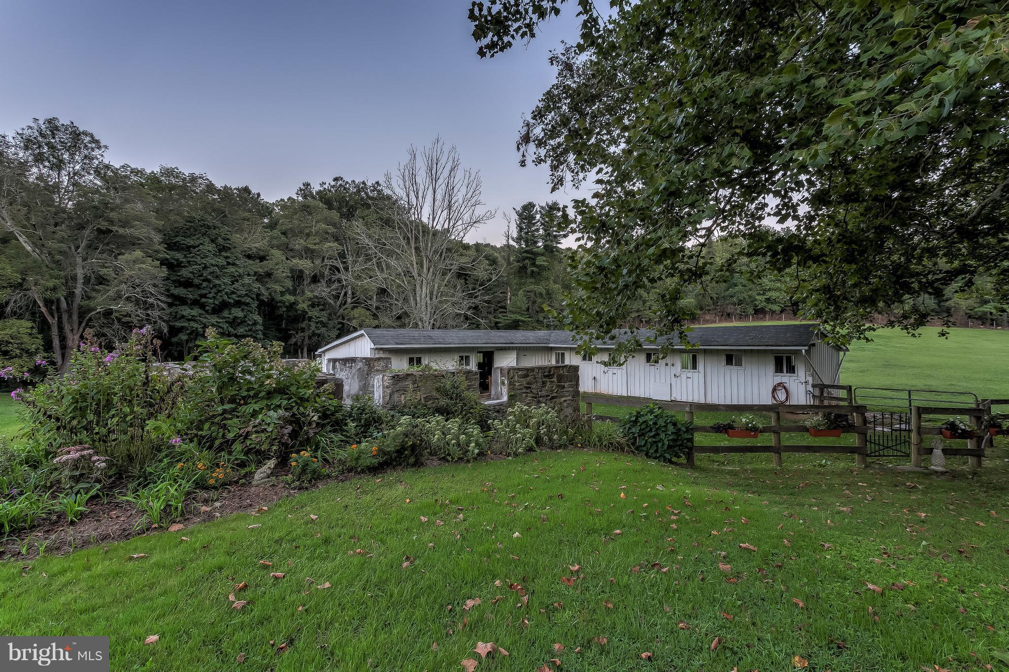 14737 Carroll Road Phoenix, MD 21131 - Photo 25 of 30 a view of a house with backyard sitting area and garden