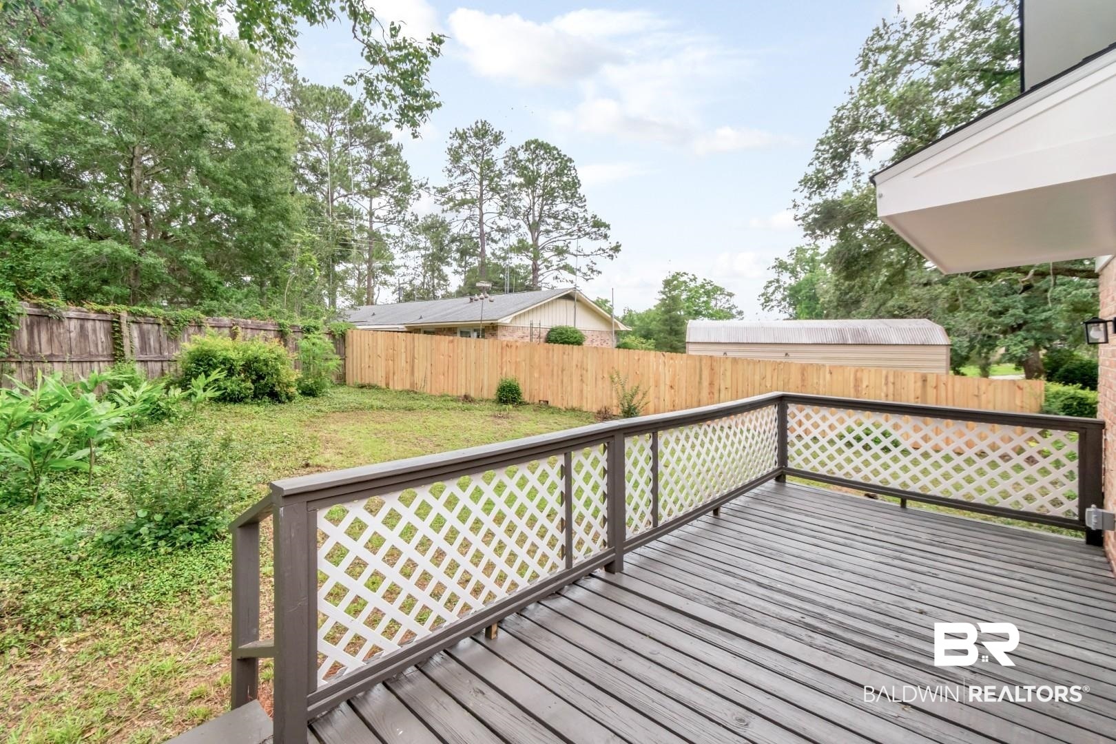 5217 Perin Road Mobile, AL 36693 - Photo 36 of 45 Spacious outdoor deck with dark wood-finish flooring and white lattice railing