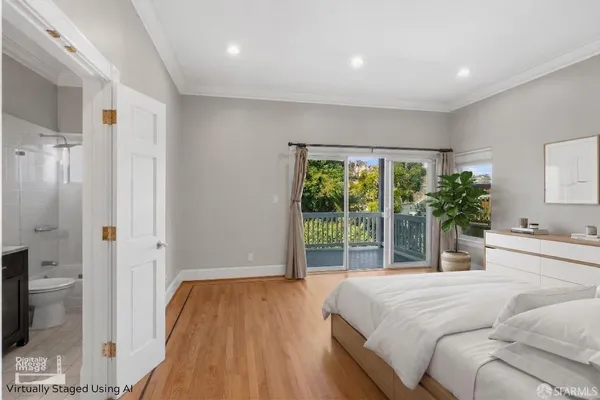 a bedroom with a large bed and a large window