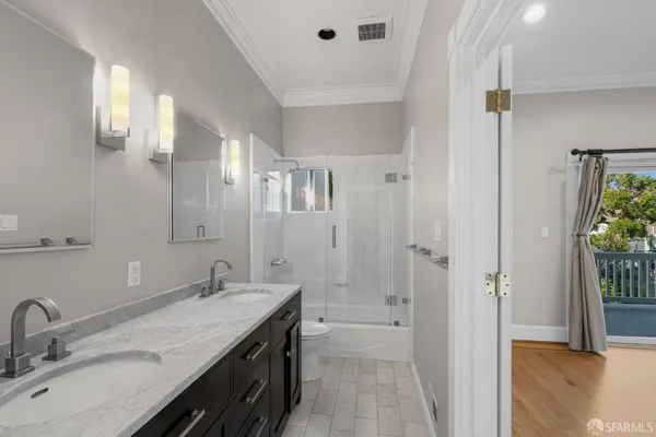 a bathroom with a double vanity sink mirror and shower