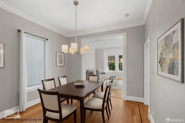 a view of a dining room with furniture window and wooden floor