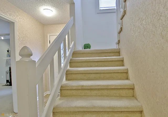 a view of a house with a wooden fence