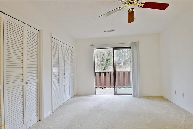 a view of a hallway with wooden floor and a living room