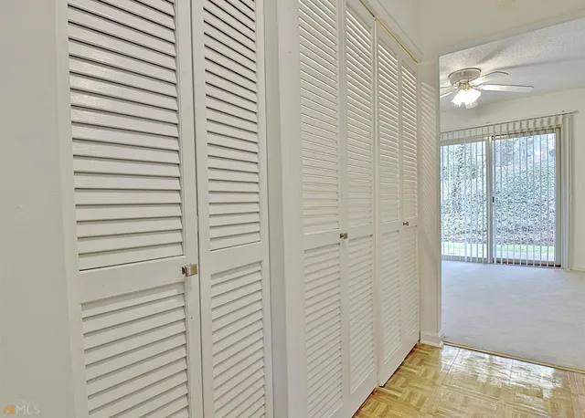 a view of a brick house with large windows and a yard