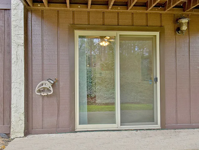 a view of a house with backyard porch and sitting area
