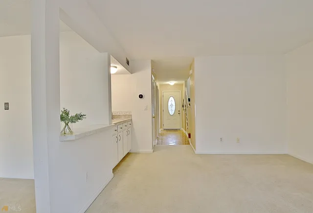 a sitting area with chairs and wooden fence