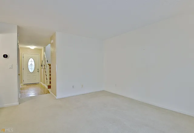 a view of a livingroom with a fireplace and a window