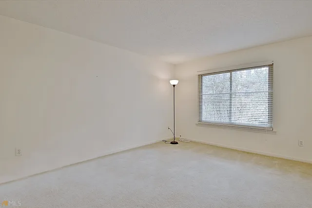 an empty room with windows and closet