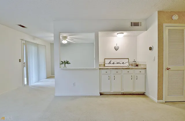 a view of an empty room with a fireplace and a window
