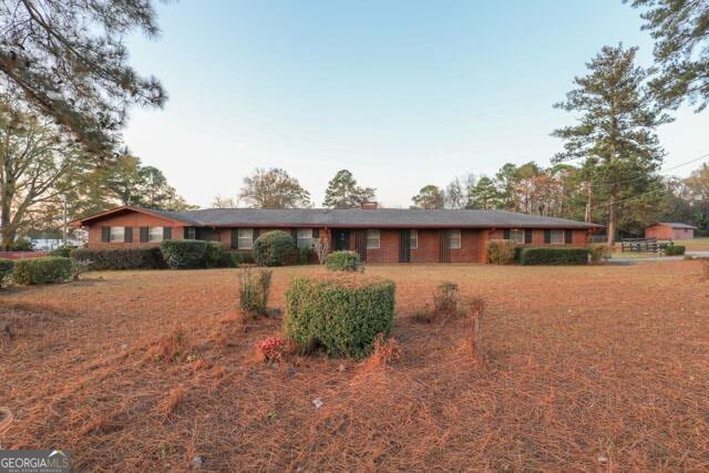 1231 Dunlap Road Northeast Milledgeville, GA 31061 - Photo 2 of 11 a front view of a house with a yard and garage
