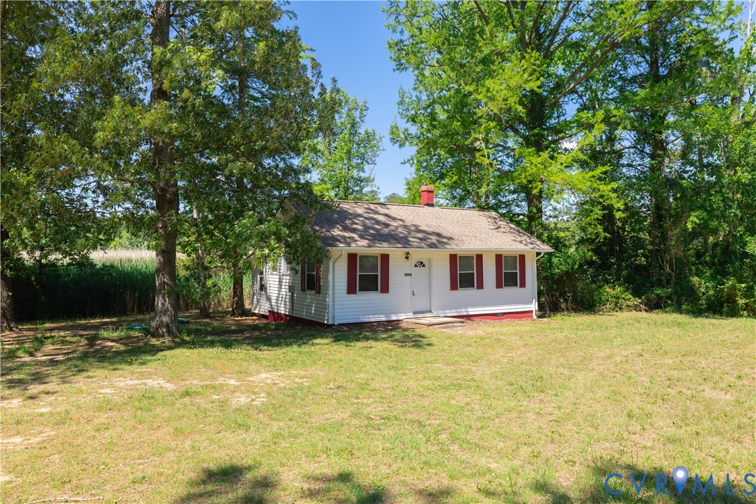 933 Pleasant Point Road Surry, VA 23883 - Photo 23 of 45 a front view of house with yard and trees in the background
