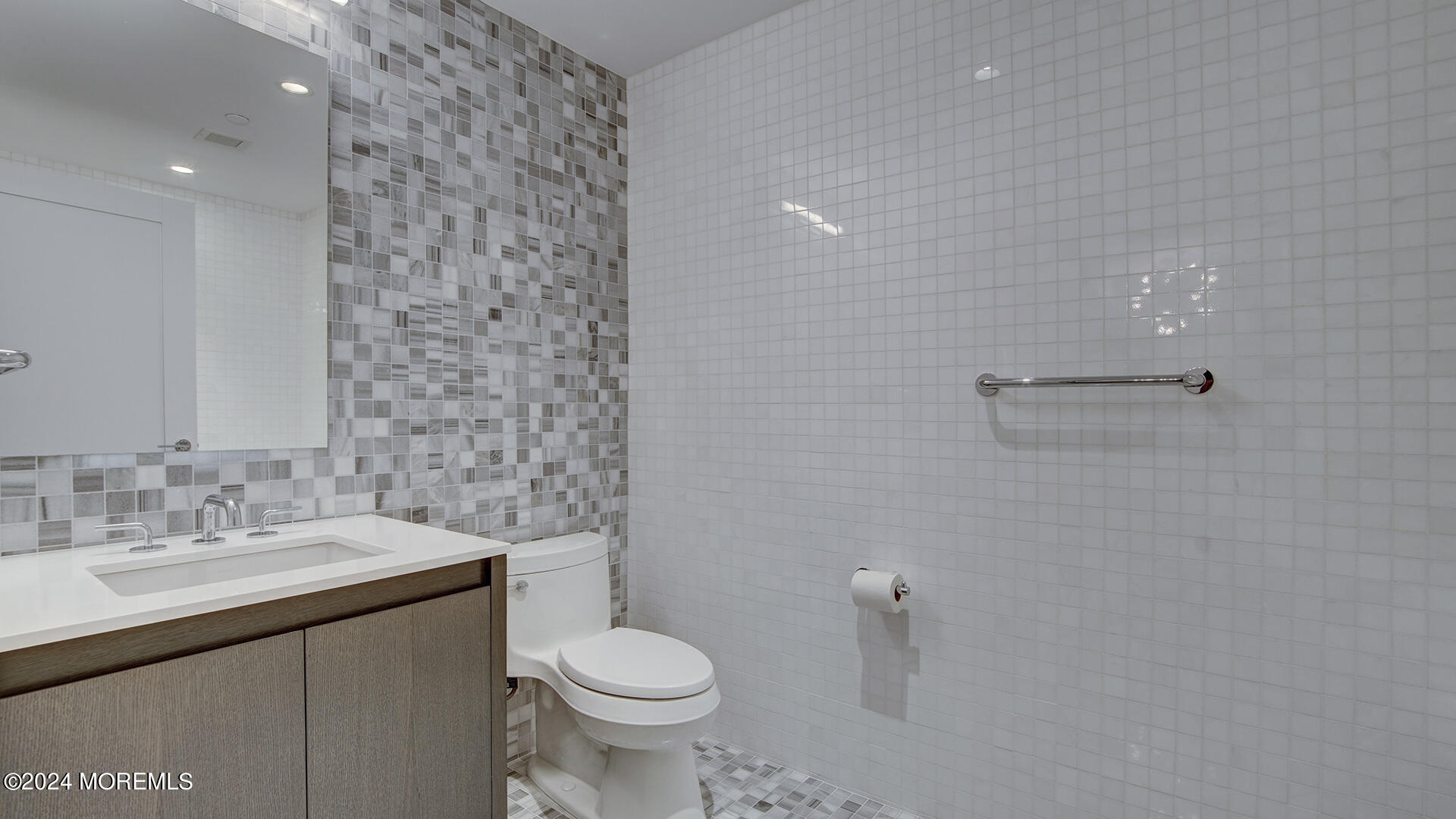 15 Morris Avenue, Unit 507 Long Branch, NJ 07740 - Photo 12 of 52 a bathroom with a sink a toilet and a mirror