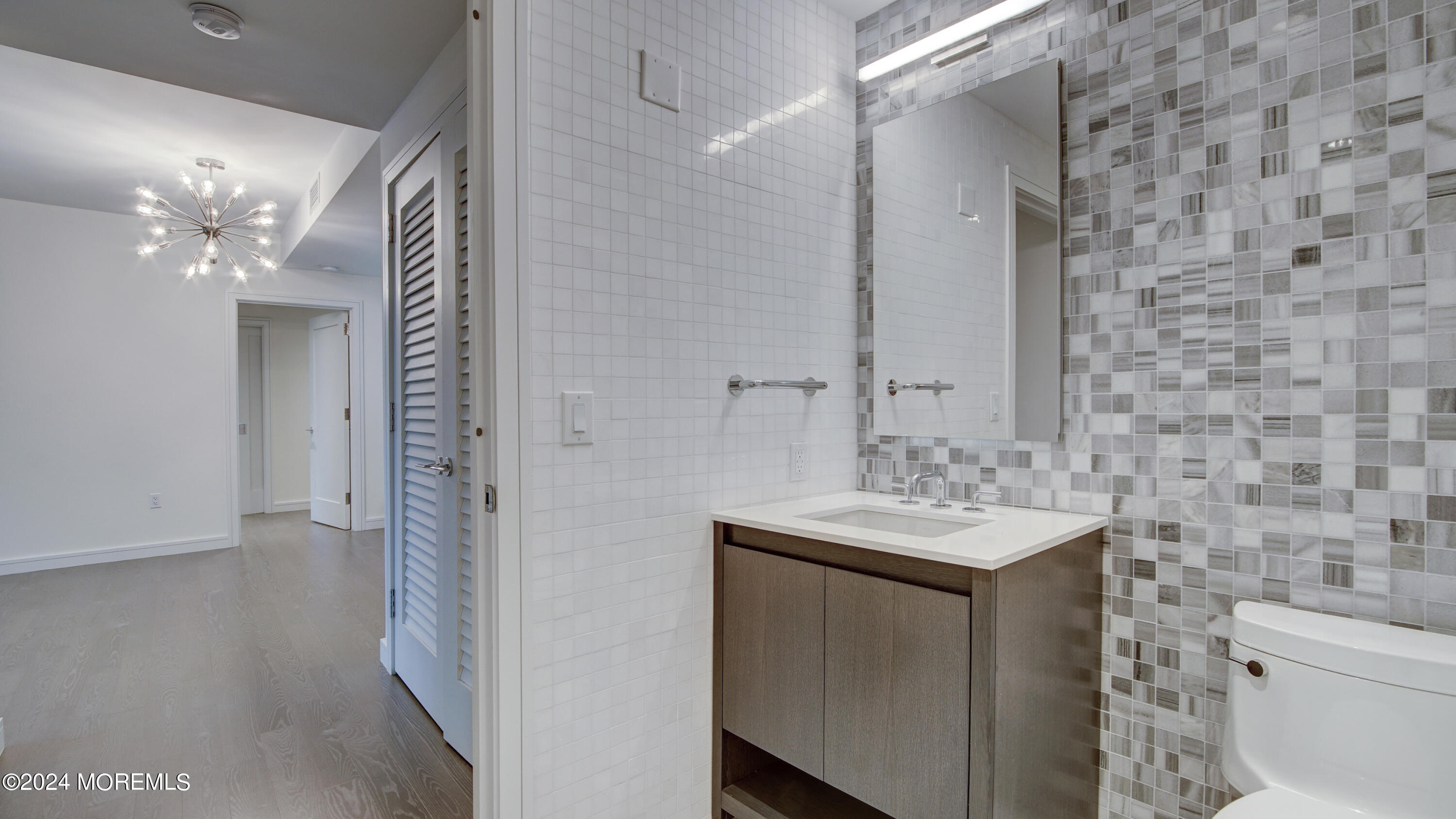15 Morris Avenue, Unit 507 Long Branch, NJ 07740 - Photo 13 of 52 a bathroom with a sink a toilet and a mirror