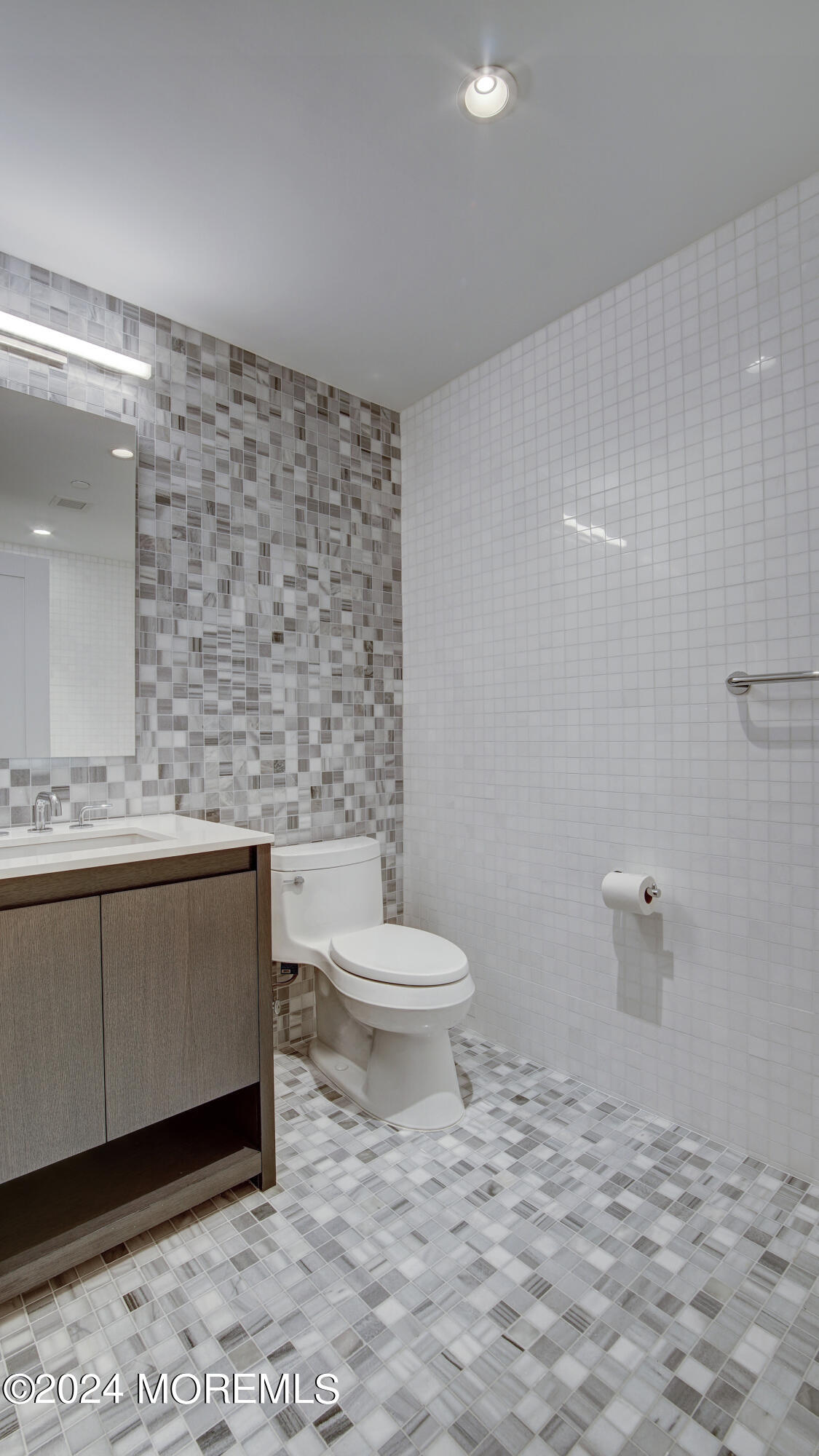 15 Morris Avenue, Unit 507 Long Branch, NJ 07740 - Photo 14 of 52 a bathroom with a toilet a sink and mirror