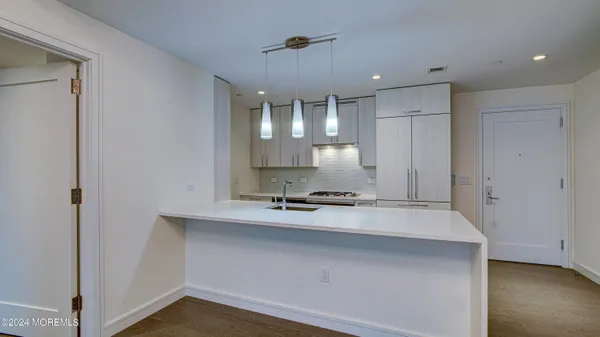 a view of a kitchen with a sink and cabinets