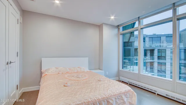 a bedroom with a large window and a balcony