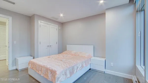 a bedroom with a bed and a mirror