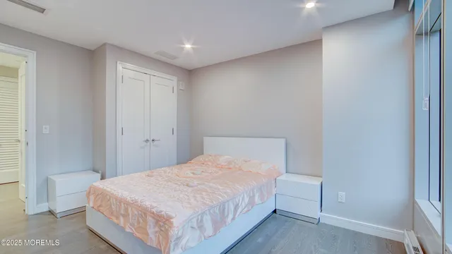 a bedroom with a bed and a mirror