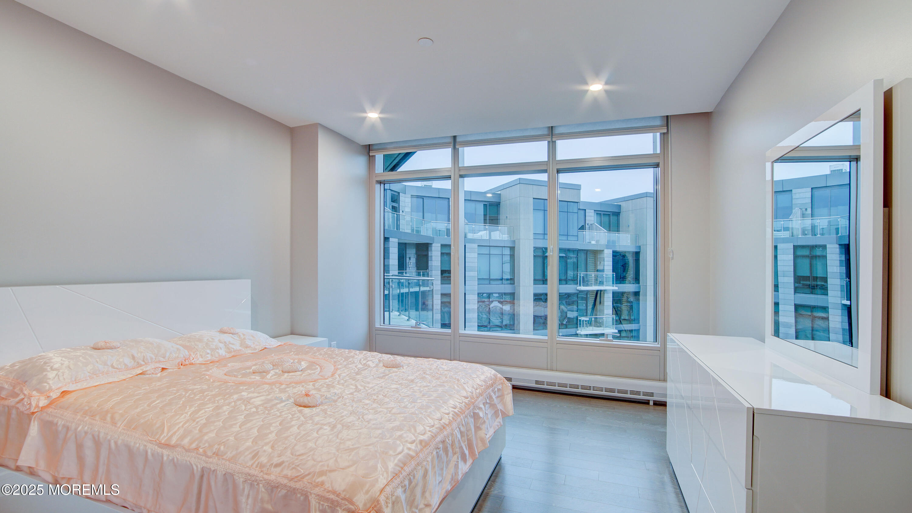 15 Morris Avenue, Unit 507 Long Branch, NJ 07740 - Photo 24 of 52 a bedroom with a large window and a balcony