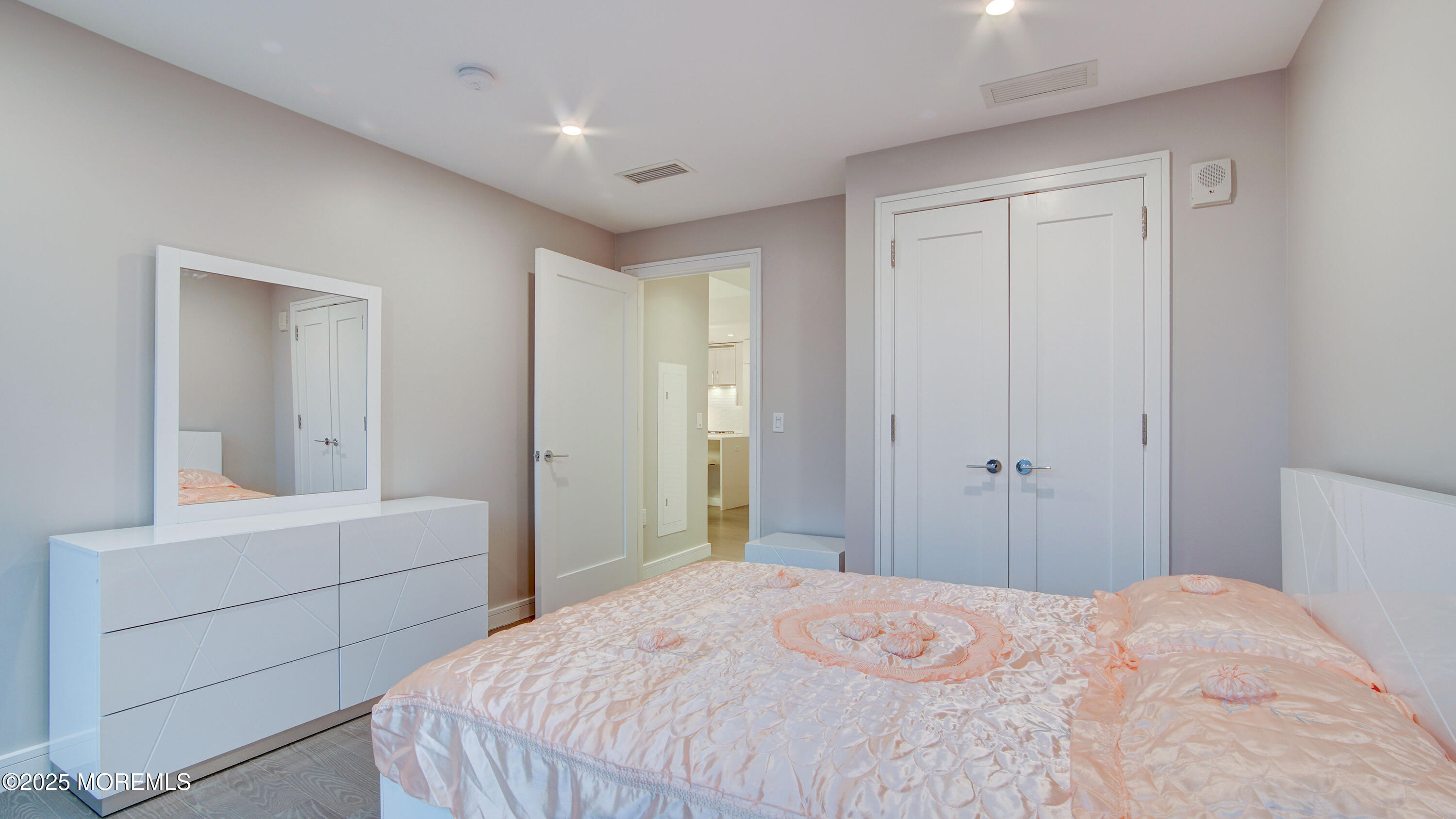 15 Morris Avenue, Unit 507 Long Branch, NJ 07740 - Photo 25 of 52 a bedroom with a bed and a mirror