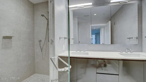 a bed sitting in a spacious bedroom next to a window