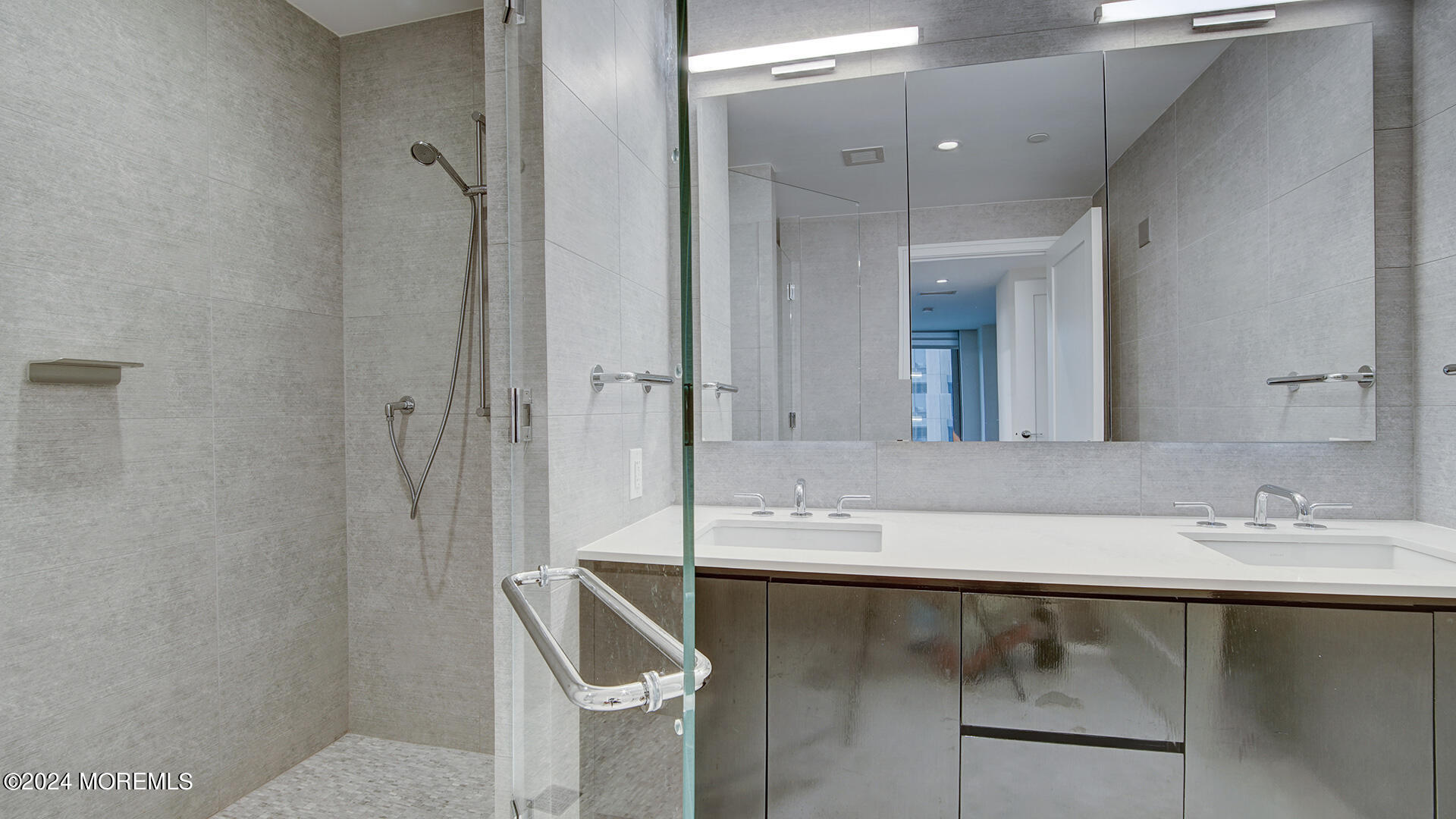 15 Morris Avenue, Unit 507 Long Branch, NJ 07740 - Photo 29 of 52 a bathroom with a granite countertop sink a mirror and shower