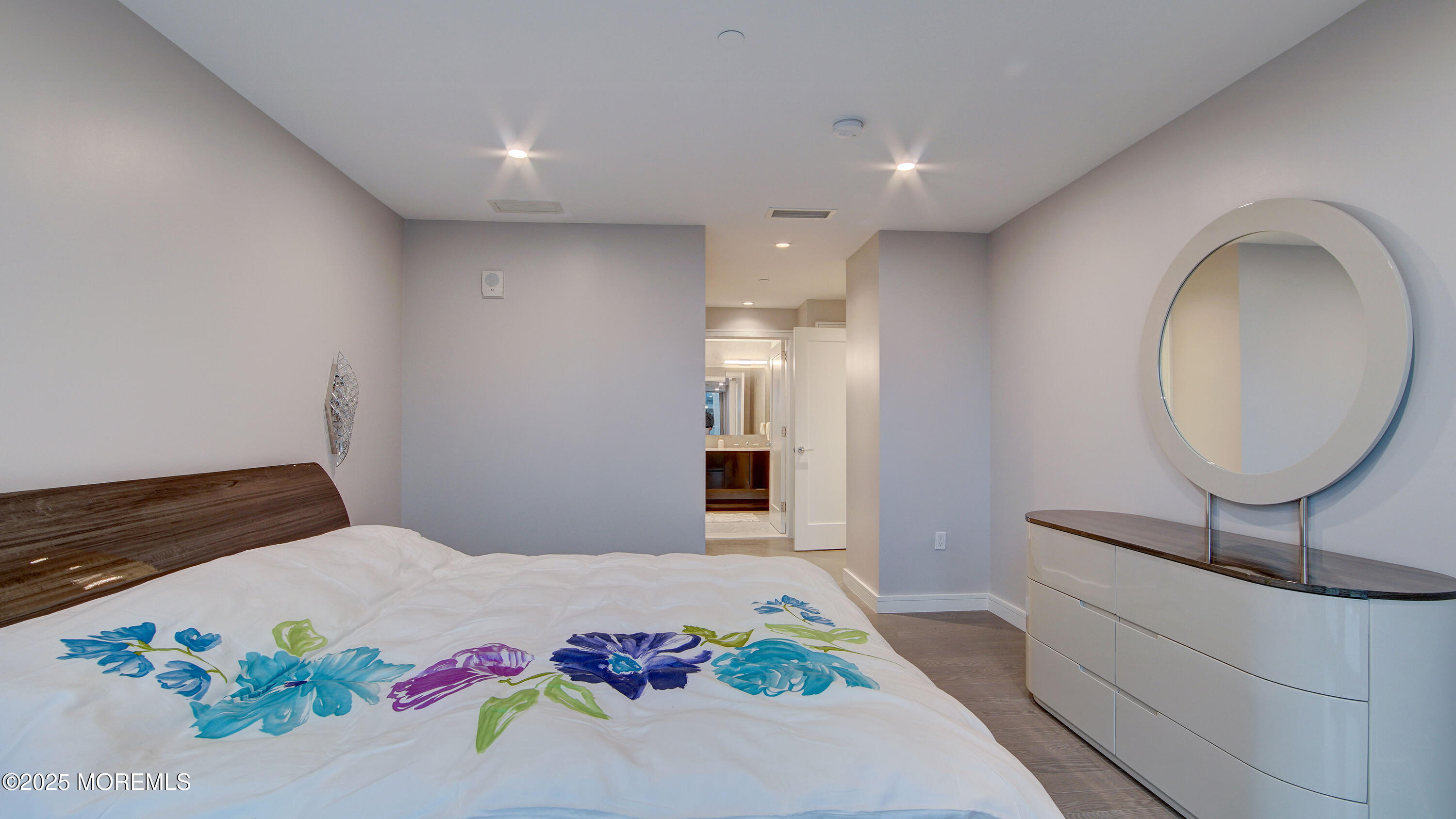 15 Morris Avenue, Unit 507 Long Branch, NJ 07740 - Photo 34 of 52 a bedroom with a bed and a chandelier