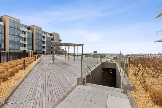 a view of large building with a yard and plants