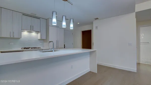 a view of kitchen and dining area with a sink