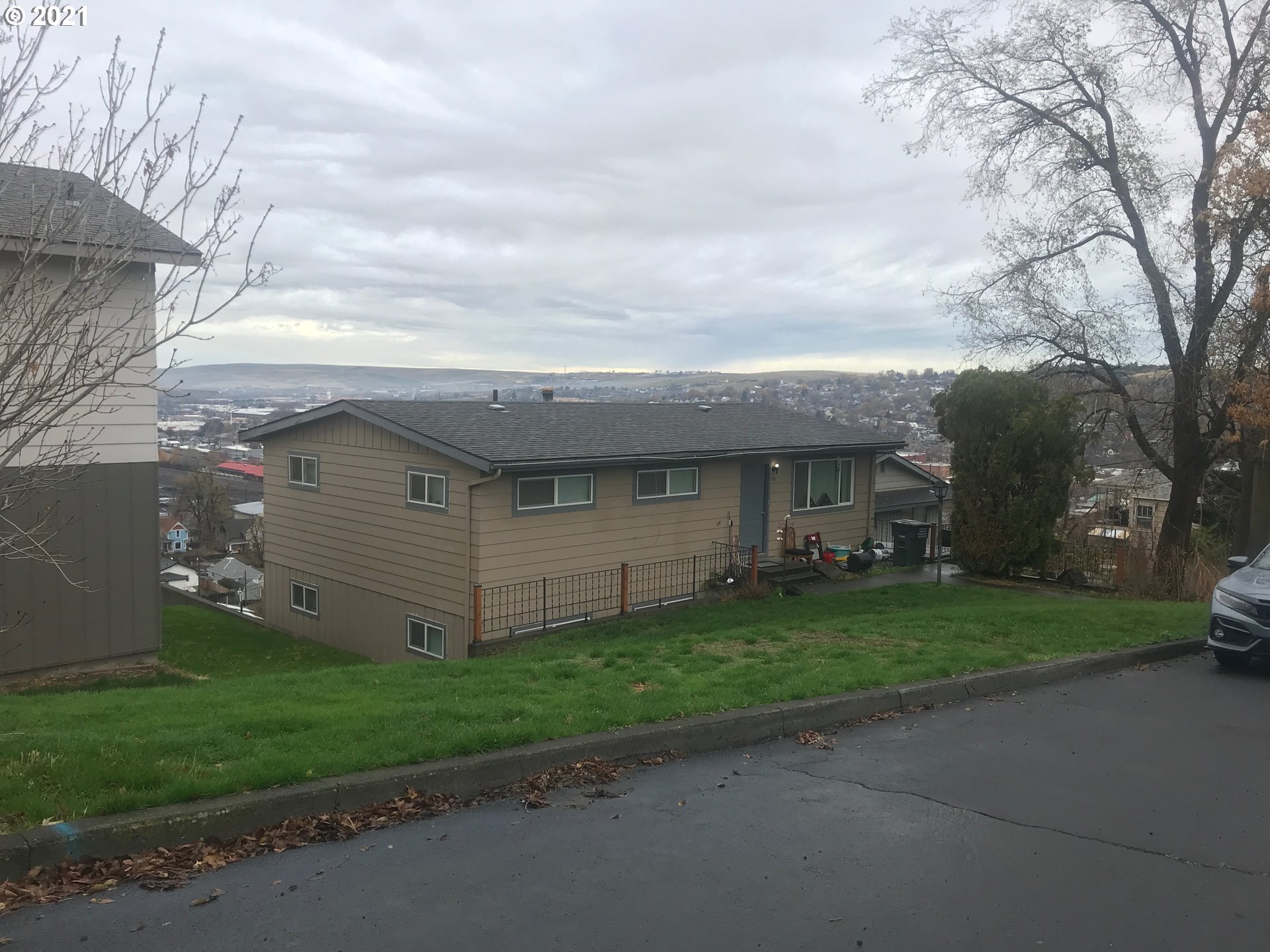 705 Southeast 6th Street Pendleton, OR 97801 - Photo 1 of 1 a view of a house with a yard and a large tree