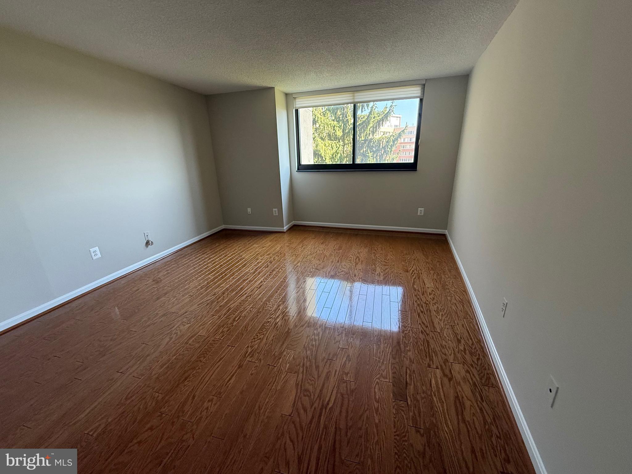 1101 South Arlington Ridge Road, Unit 214 Arlington, VA 22202 - Photo 25 of 41 an empty room with wooden floor and windows