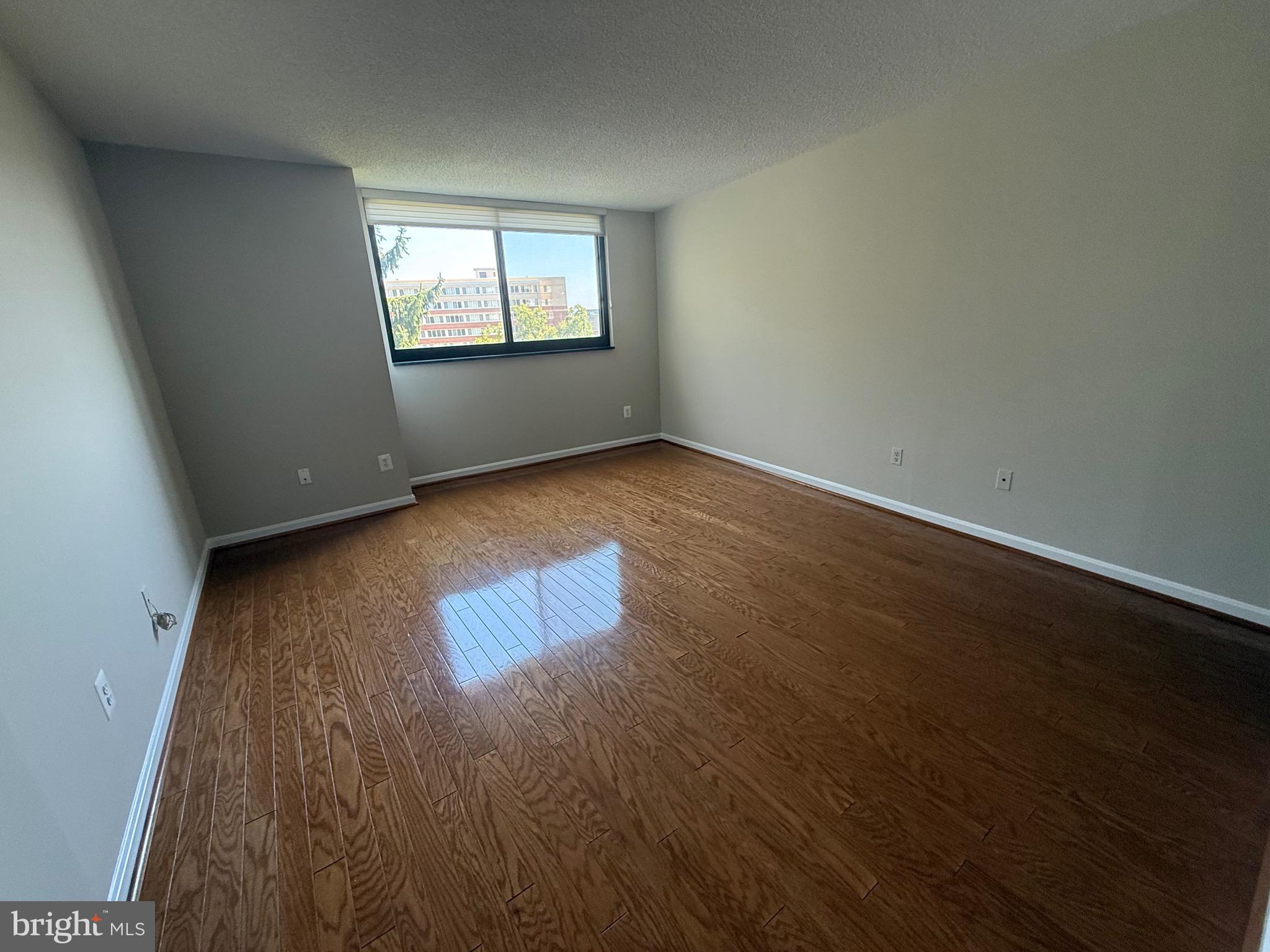 1101 South Arlington Ridge Road, Unit 214 Arlington, VA 22202 - Photo 27 of 41 an empty room with wooden floor and windows