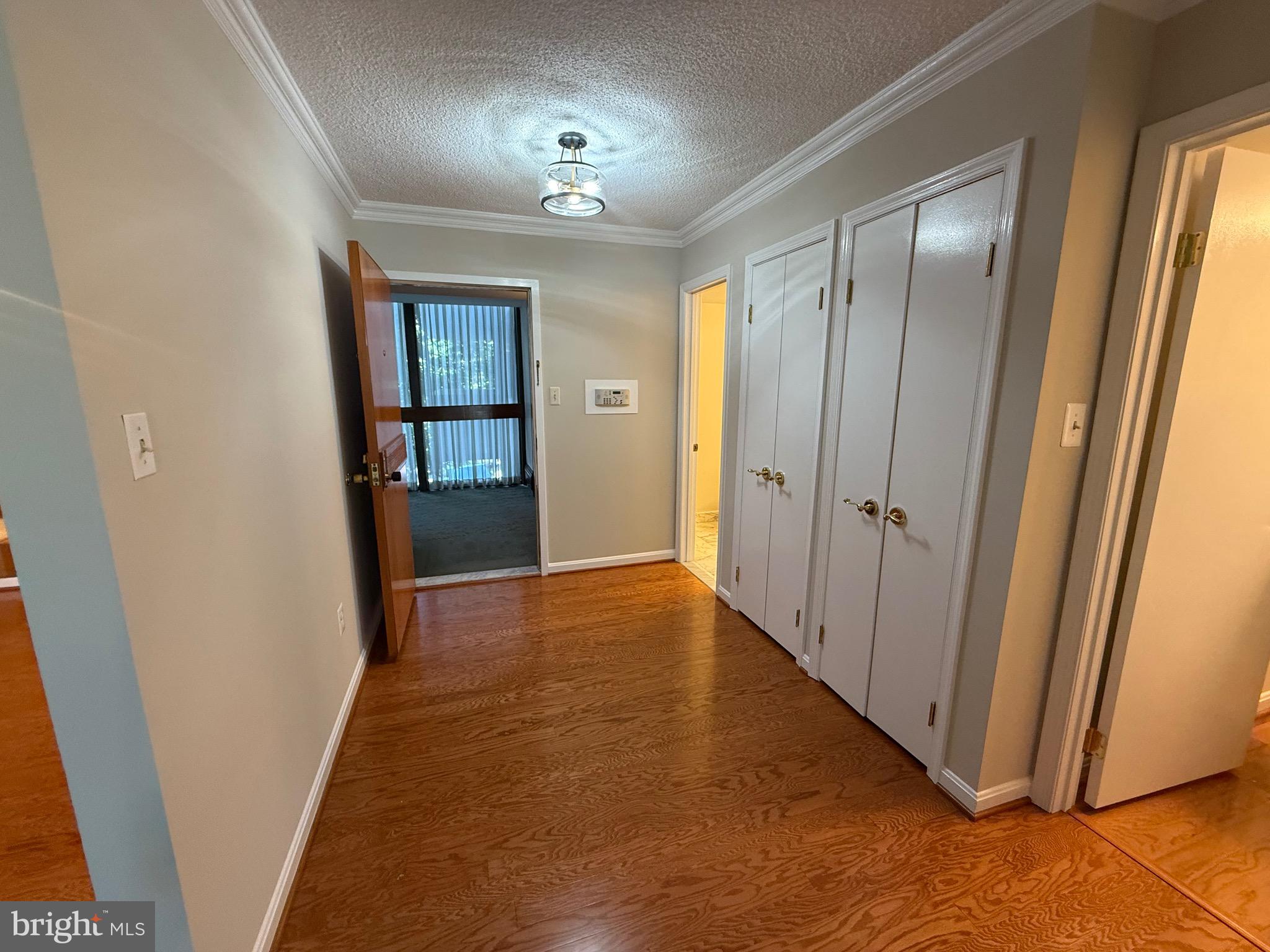 1101 South Arlington Ridge Road, Unit 214 Arlington, VA 22202 - Photo 3 of 41 a view of a hallway with wooden floor and staircase
