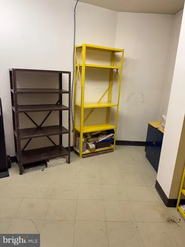 a view of a yard with flower plants and wooden fence