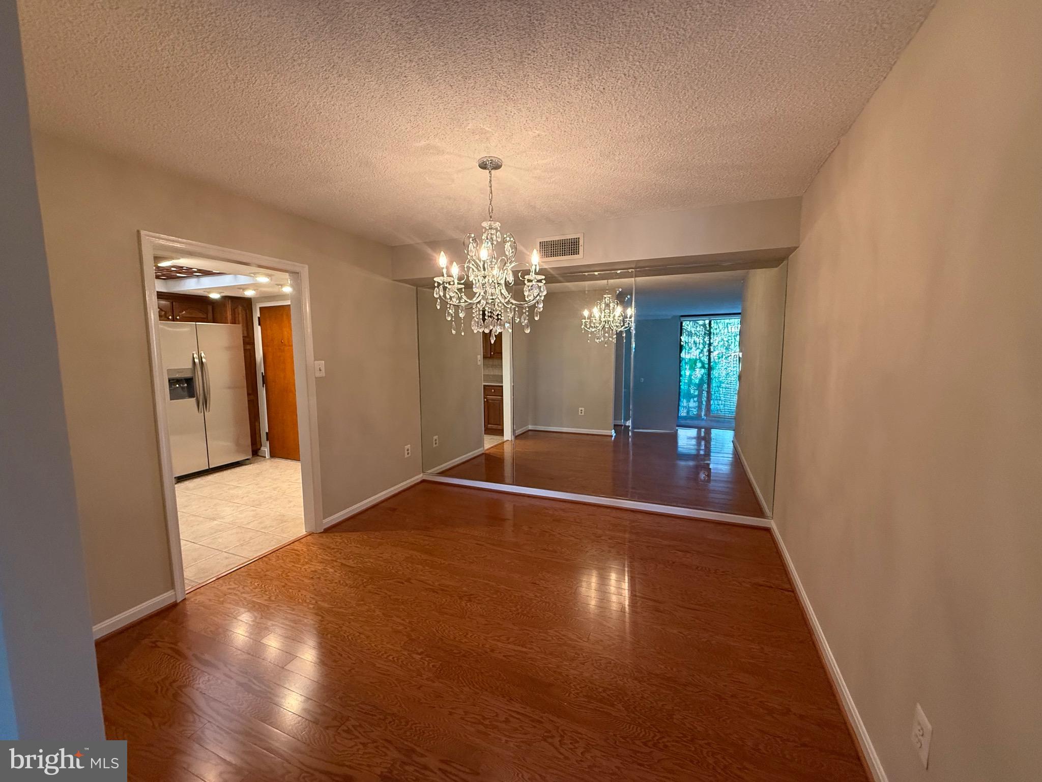 1101 South Arlington Ridge Road, Unit 214 Arlington, VA 22202 - Photo 9 of 41 a view of a livingroom with a chandelier