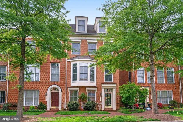 front view of a brick house with a yard