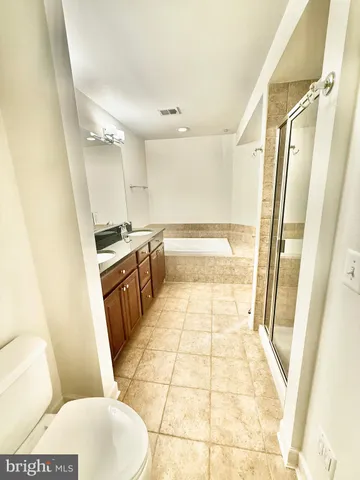 an empty room with a ceiling fan and a window