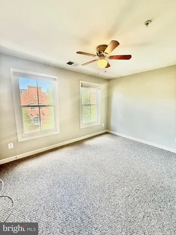 a view of a livingroom with a ceiling fan and window