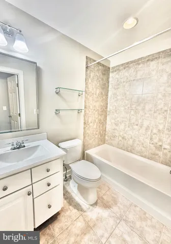 front view of a brick house with a yard