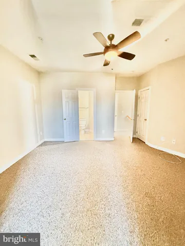 a view of swimming pool with seating area and trees in the background