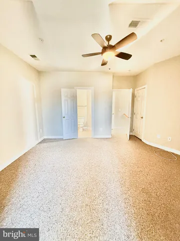 a view of a livingroom with wooden floor and windows