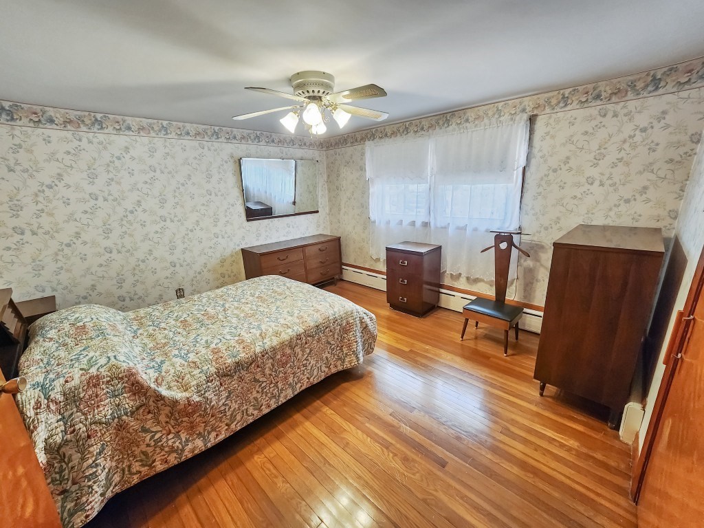 415 Chase Road Dartmouth, MA 02747 - Photo 16 of 34 a bedroom with a bed and wooden floor