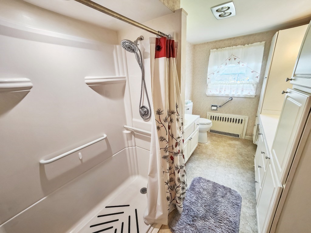 415 Chase Road Dartmouth, MA 02747 - Photo 18 of 34 a living room with a bed and a rug