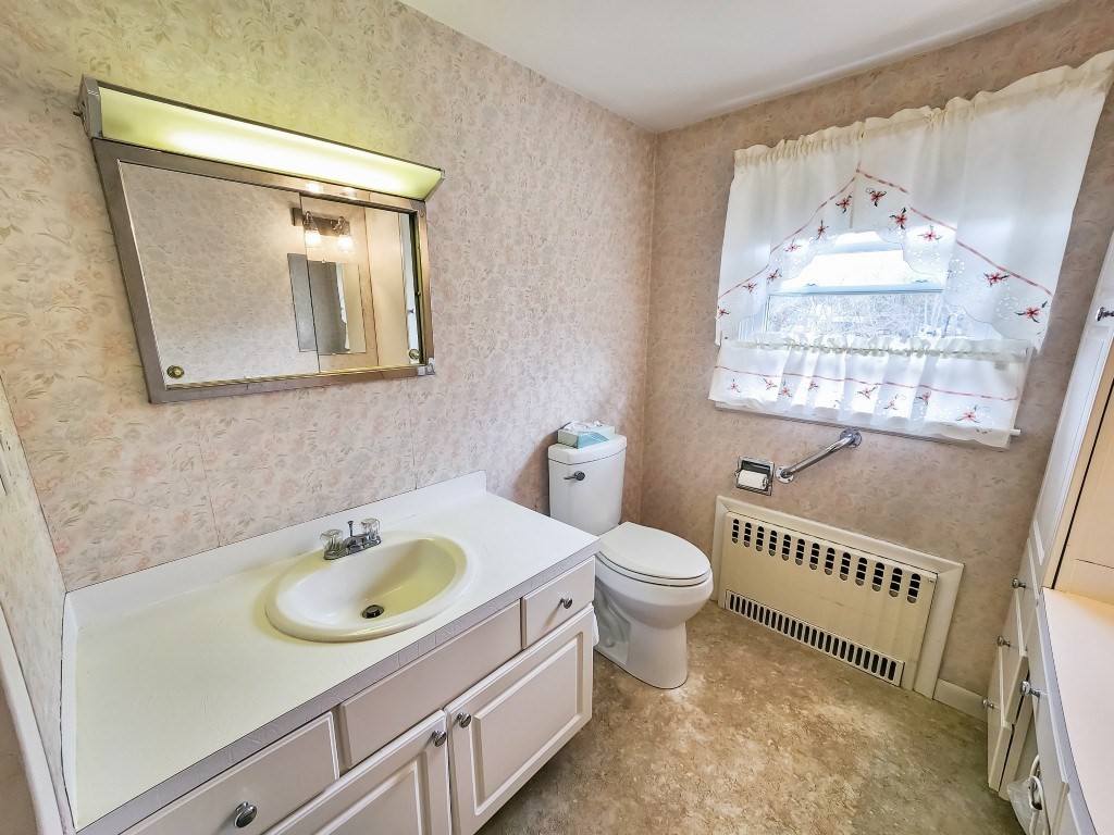 415 Chase Road Dartmouth, MA 02747 - Photo 20 of 34 a bathroom with a sink a toilet and a window