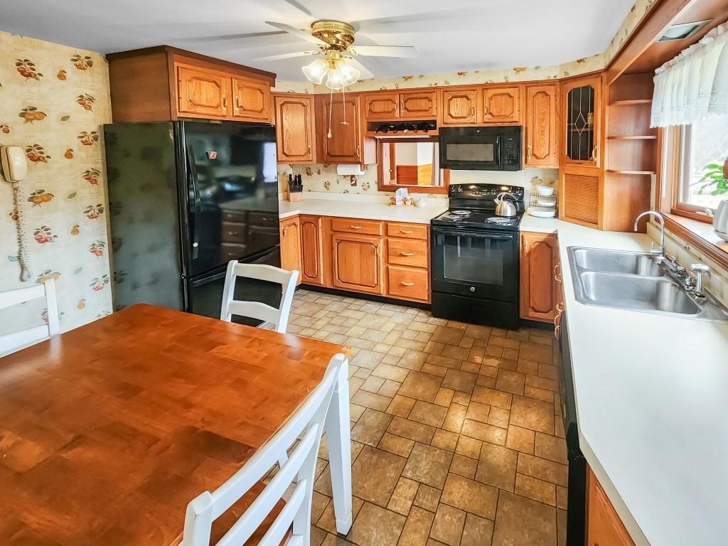 415 Chase Road Dartmouth, MA 02747 - Photo 4 of 34 a kitchen with stainless steel appliances a stove a sink a refrigerator cabinets and dining table