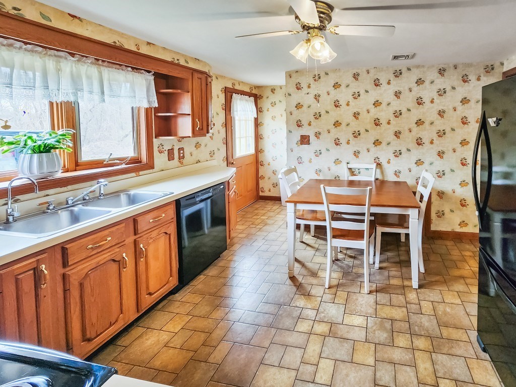 415 Chase Road Dartmouth, MA 02747 - Photo 6 of 34 a kitchen with stainless steel appliances a sink and a table
