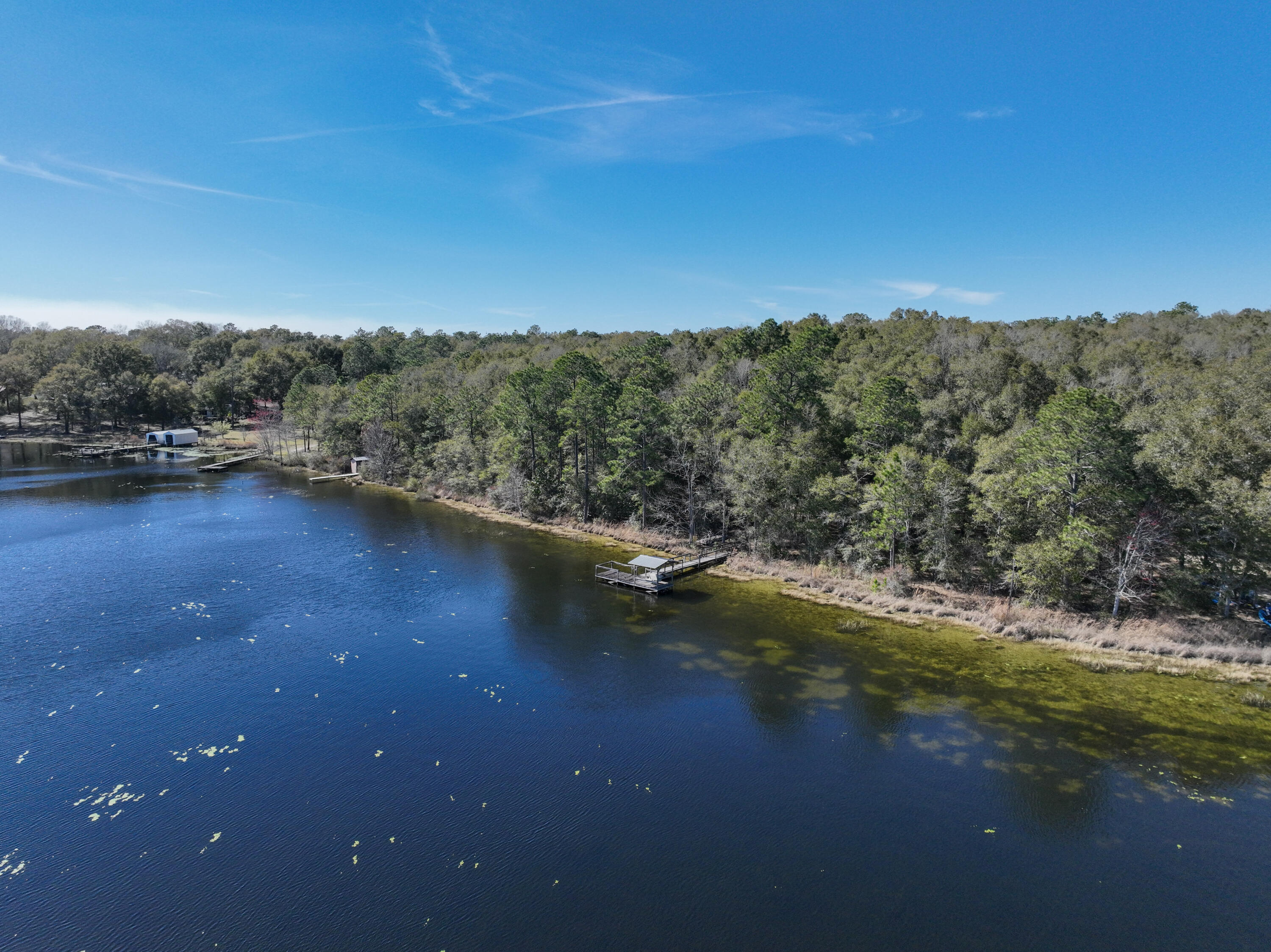299 Holley King Road DeFuniak Springs, FL 32433 - Photo 14 of 40 a view of a lake with a mountain