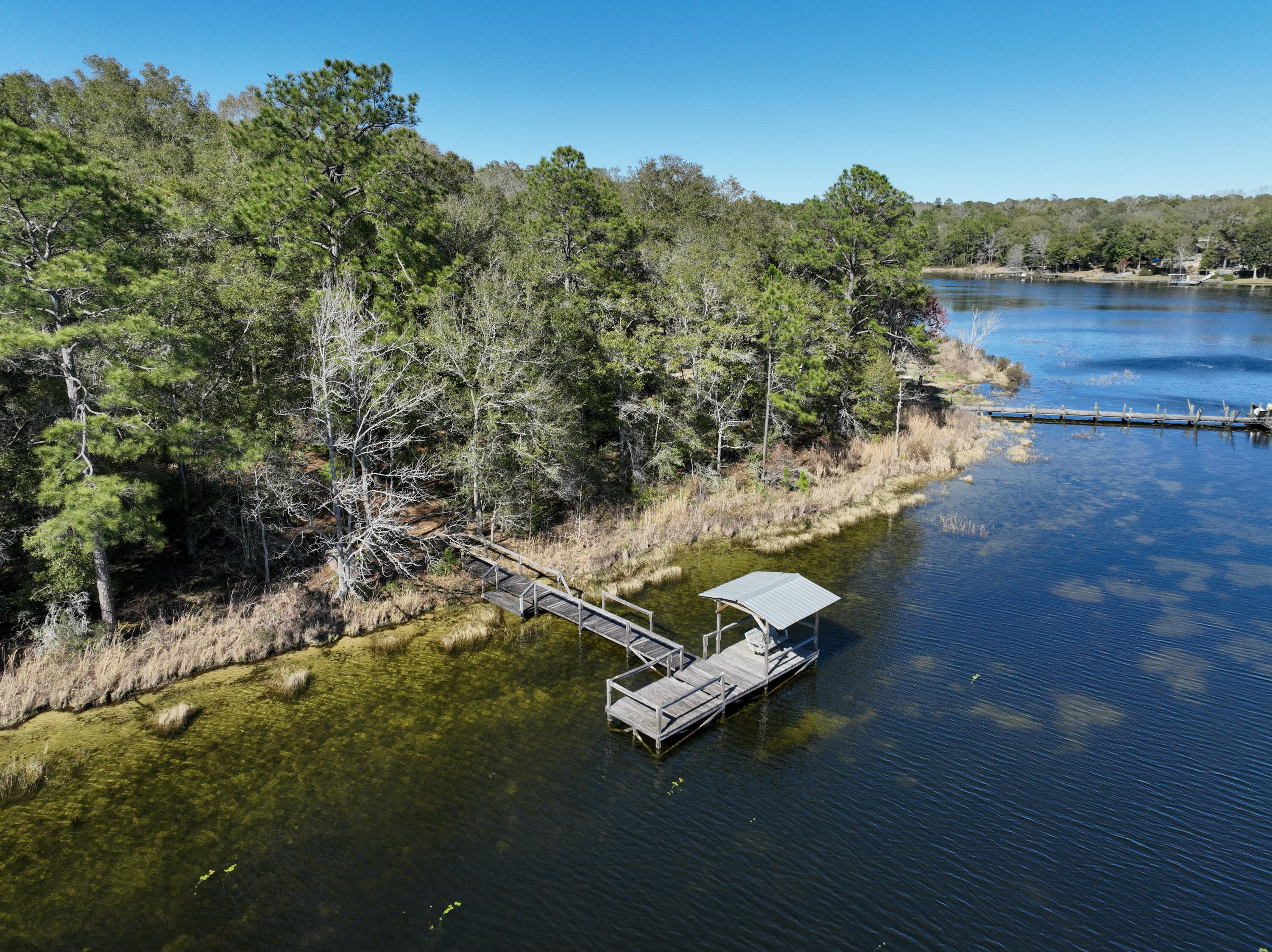 299 Holley King Road DeFuniak Springs, FL 32433 - Photo 20 of 40 a view of a lake with a mountain